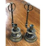 A pair of antique brass hanging candlesticks