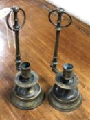 A pair of antique brass hanging candlesticks