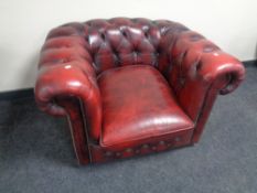 A red button leather Chesterfield club armchair