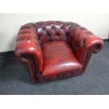 A red button leather Chesterfield club armchair