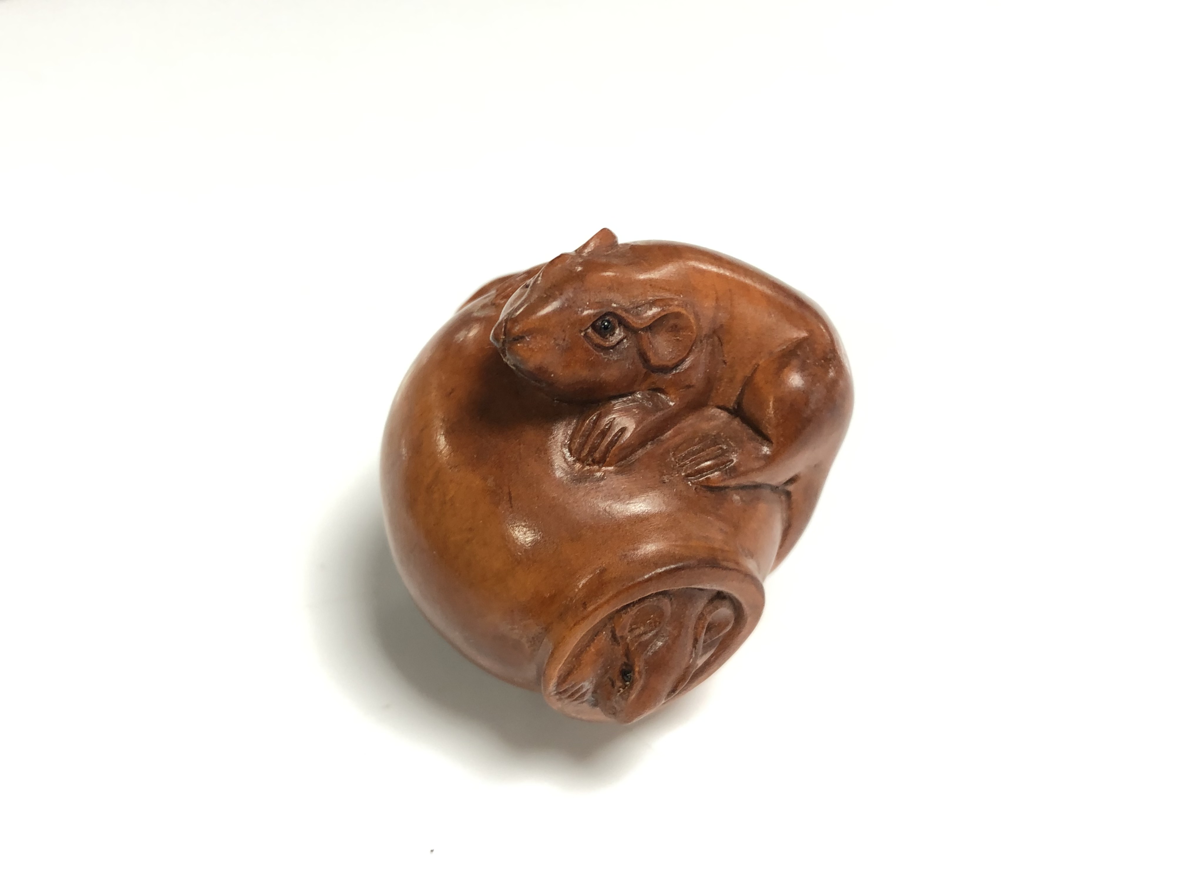 A carved Chinese hardwood netsuke - Two rats on a pot