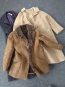 A box containing three lady's coats to include sheepskin,