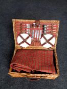 A wicker cased picnic set together with a treen and plated lidded biscuit barrel