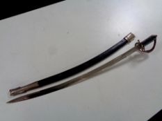 An Indian sword in sheath with etched blade