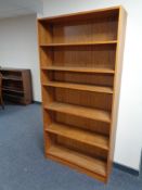 A set of 20th century teak veneered open bookshelves