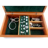 A jewellery box containing a collection of silver jewellery to include rings, bracelets,