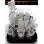A tray containing assorted drinking glasses together with two lead crystal whiskey decanters