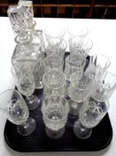 A tray containing assorted drinking glasses together with two lead crystal whiskey decanters