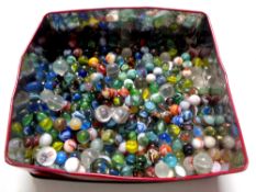 A tin containing glass marbles