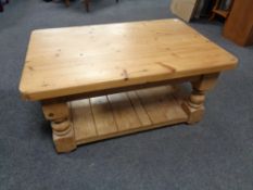 A stripped pine two tier coffee table
