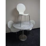 A circular marble topped metal based bistro style table together with a set of three contemporary