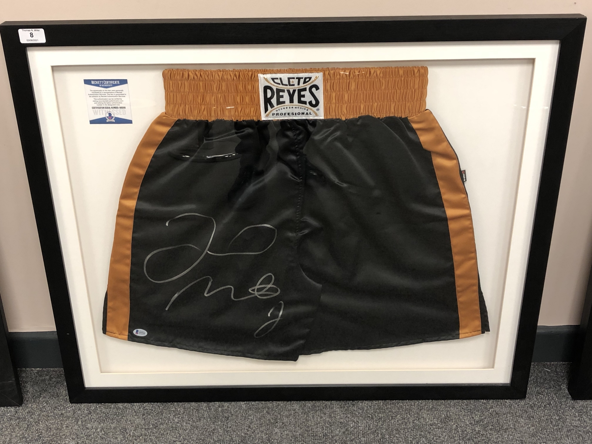 A sporting memorabilia montage : A signed pair of boxing shorts, Floyd Mayweather Jr.