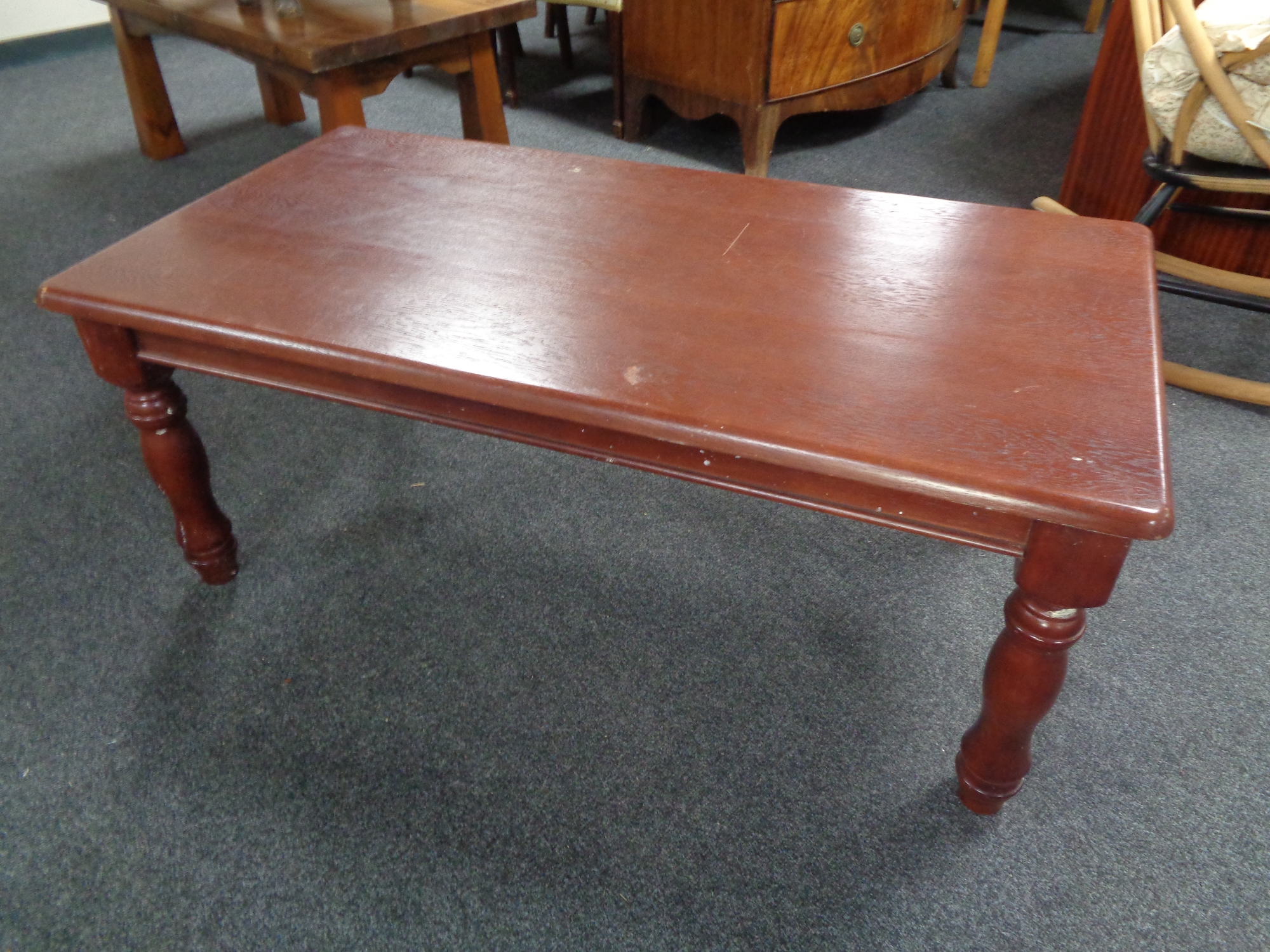 A contemporary coffee table in an antique finish