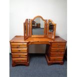 A Ducal pine eight drawer dressing chest with triple mirror