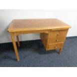 A 20th century oak single pedestal desk fitted three drawers and a slide