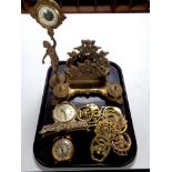 A tray containing assorted brass wares to include ornate desk stand with inkwells, figural clock,