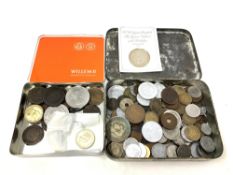 Two vintage tins containing a collection of old coins, including; George III and later pennies,