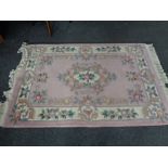 A pink floral fringed Chinese rug