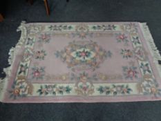 A pink floral fringed Chinese rug