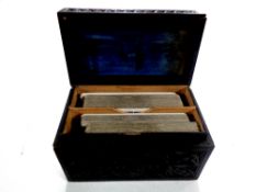 A carved ebonised card box