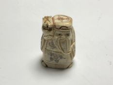 A carved Chinese bone netsuke - Village elder holding a staff