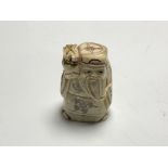 A carved Chinese bone netsuke - Village elder holding a staff