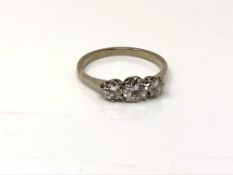 A good antique platinum three stone diamond ring, the central stone approximately 0.5ct. Size M.