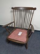 An Ercol spindle back armchair (no cushions) in an antique finish
