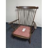 An Ercol spindle back armchair (no cushions) in an antique finish