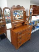 An Edwardian walnut three drawer dressing chest with triple mirror