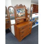 An Edwardian walnut three drawer dressing chest with triple mirror