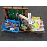 Two boxes containing tabletop foosball, light up badges, Wallace and Gromit novelty clock,