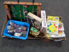 Two boxes containing tabletop foosball, light up badges, Wallace and Gromit novelty clock,