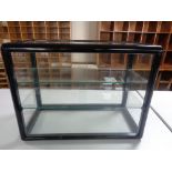 A counter top display cabinet with sliding glass doors