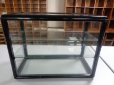 A counter top display cabinet with sliding glass doors