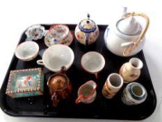 A tray containing oriental wares to include teapots, teacups and tea bowls,