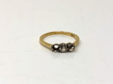 An 18ct gold ring set with two paste stones, one missing, size Q.