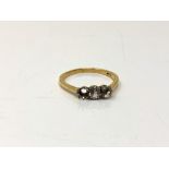 An 18ct gold ring set with two paste stones, one missing, size Q.