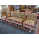 A three piece wood and bergere framed lounge suite upholstered in a pink brocade fabric