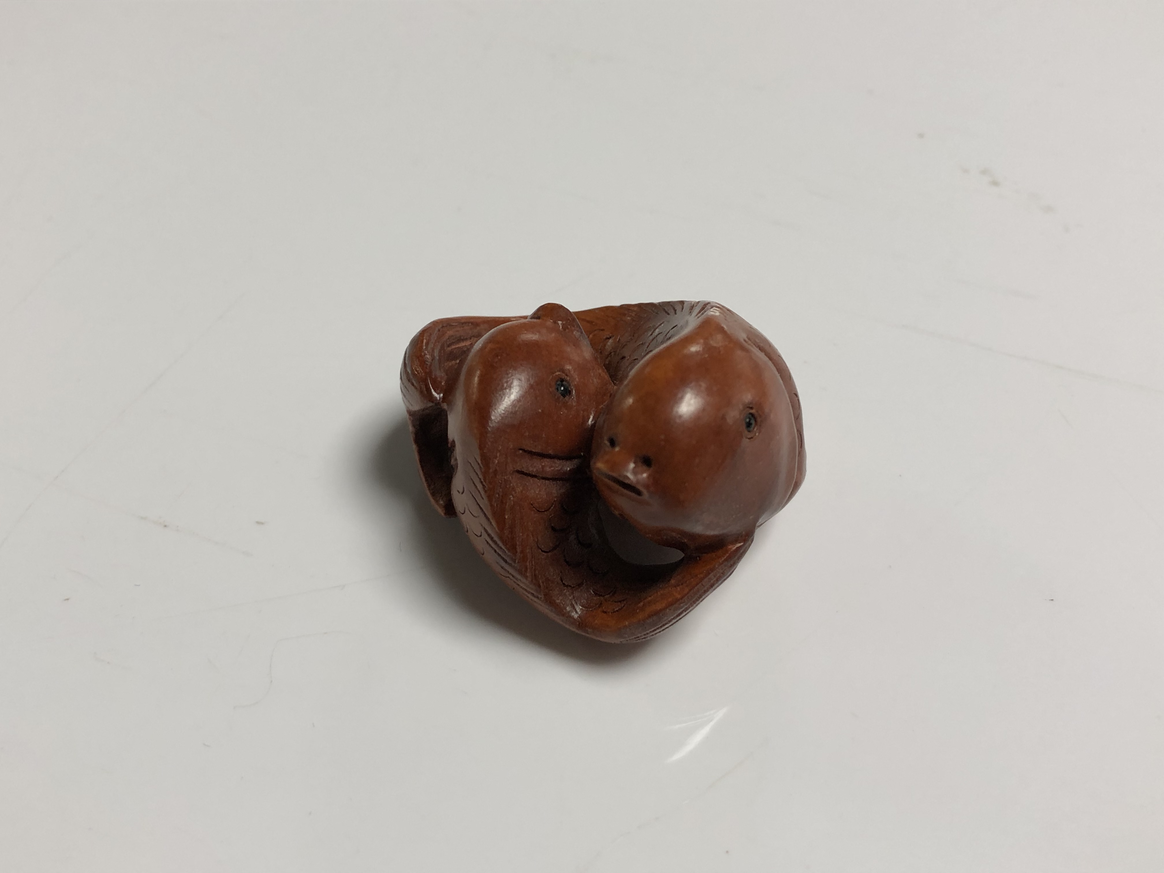 A carved Chinese hardwood netsuke - Two carp