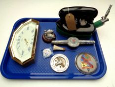 A tray containing a vintage Rhythm gas iron, car badges, Italian pin badge,