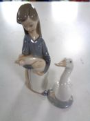 A Lladro figure, girl with pig,