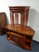 An inlaid yew wood corner entertainment stand together with matching nest of three tables