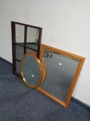 A pine framed mirror together with a sectional mirror and an oval teak framed mirror