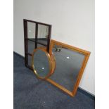 A pine framed mirror together with a sectional mirror and an oval teak framed mirror