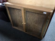 A pine wall mounted notice board cabinet