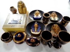 A box containing assorted Egyptian and Grecian wall plates, figurines,