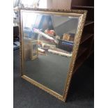 A gilt framed bevel edged overmantel mirror