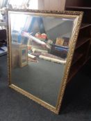 A gilt framed bevel edged overmantel mirror