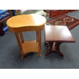 A kidney shaped two tier occasional table fitted a drawer together with a further pedestal